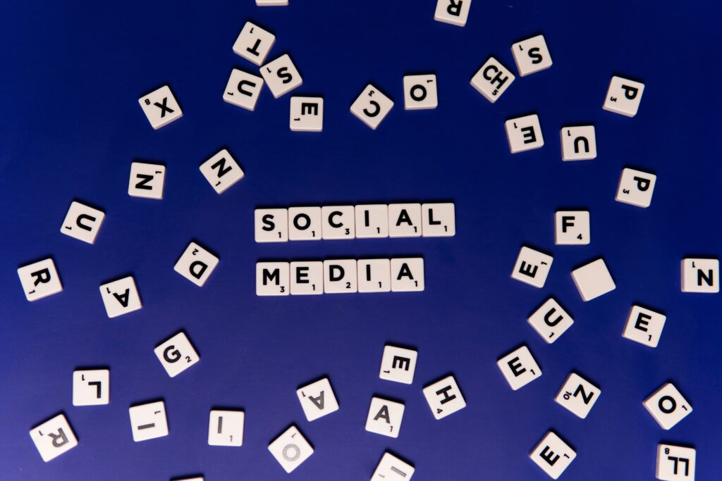 Home Scrabble tiles spelling 'Social Media' on a blue background, ideal for digital marketing themes.