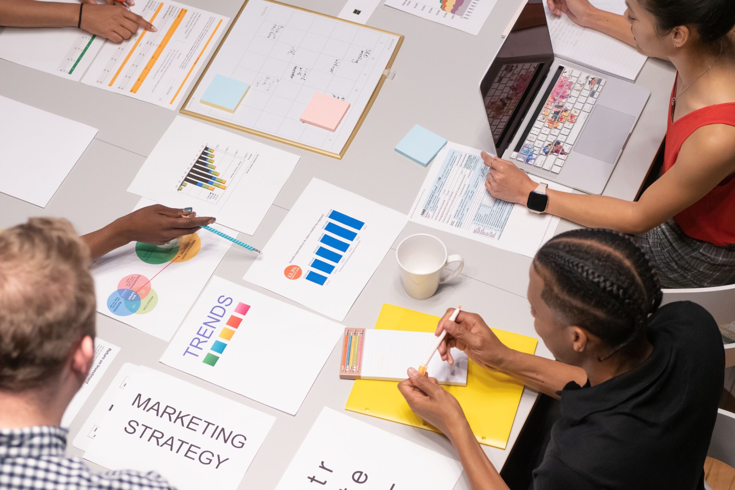 Home Overhead shot of diverse team analyzing marketing strategies with charts and graphs.